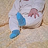 baby, infant, smiling, blue_headband, blue_socks, white_outfit, blanket, soft_texture, sitting, happy, cute, child, portrait, indoors, cozy, warm, comfortable, playful, small_hand, headband
