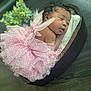 baby, newborn, sleeping, infant, pink_tutu, fairy_wings, wooden_bowl, cushion, curly_hair, face, peaceful, portrait, indoors, soft_lighting, greenery, floor, cute, costume, tulle, resting