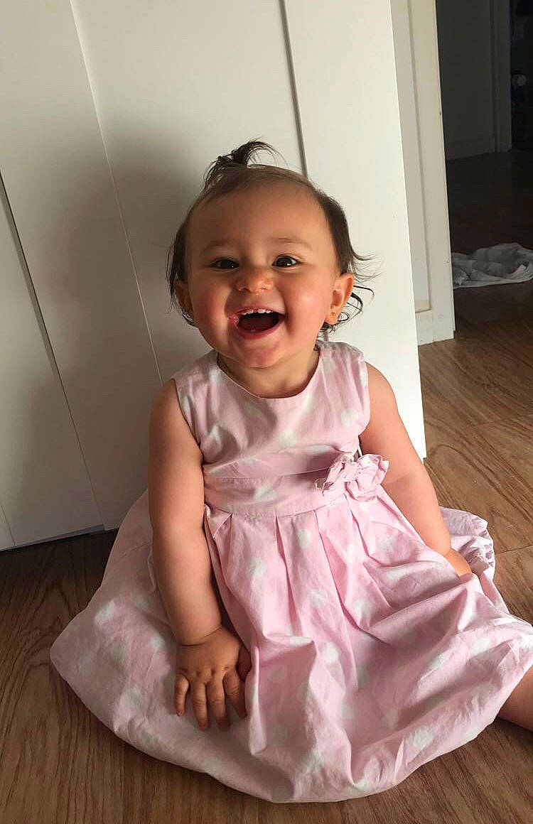 Gabriella a rejoint le concours — aidez-le/la à gagner de superbes lots ! arm, baby, baby_toddler_clothing, cheek, day_dress, door, dress, flash_photography, flooring, fun, happy, iris, magenta, person, pink, shoulder, sitting, skin, sleeve, smile