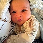 Charlie is registered to the contest to win money with this photo: baby, infant, face, blanket, clothing, sleepwear, cozy, soft, cute, child, portrait, closeup, skin, hand, eyebrows, cheeks, indoors, warm, resting, newborn