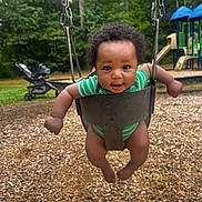 Deomari joined the competition — help win amazing prizes! baby, child, swing, playground, green_onesie, wood_chips, trees, stroller, smiling, outdoor, daylight, happy, infant, play, fun, park, person, seat, metal_chains, nature