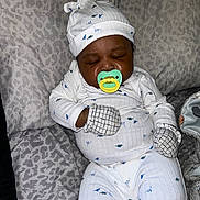 Deomari joined the competition — help win amazing prizes! baby, sleeping, pacifier, mittens, hat, pajamas, dinosaur_pattern, bed, blanket, infant, cozy, cute, child, resting, indoors, soft_fabric, comfort, peaceful, person, newborn