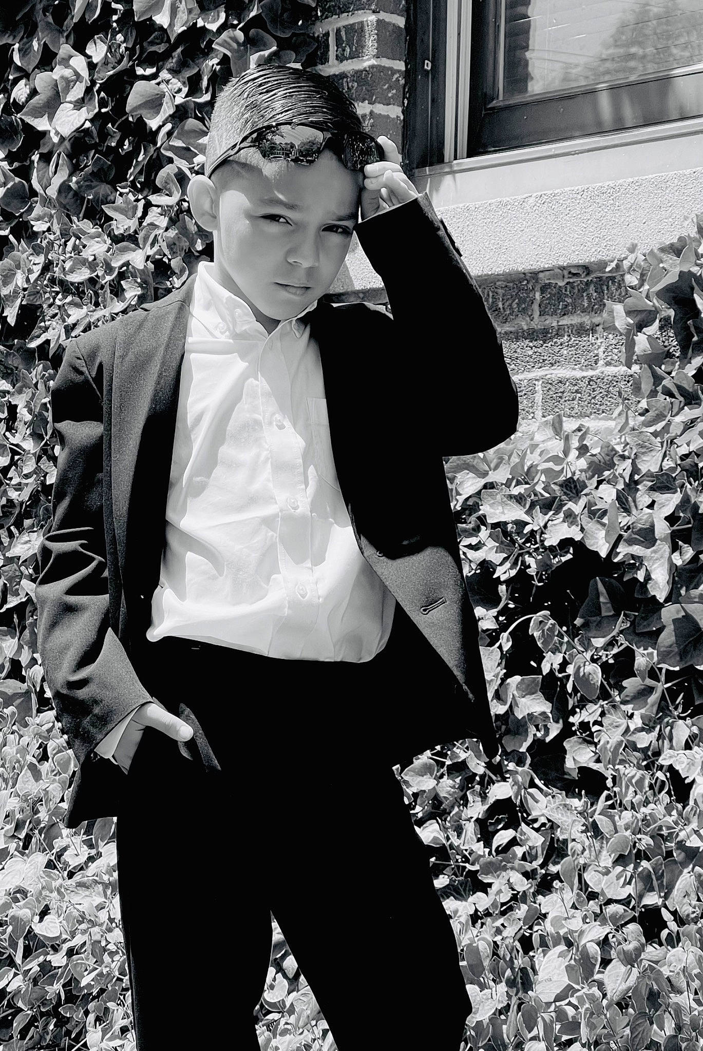 Dillan is registered to the contest to win money with this photo: black, black_and_white, blazer, dress_shirt, eyewear, flash_photography, formal_wear, gesture, headwear, monochrome, monochrome_photography, people_in_nature, person, photograph, plant, sleeve, standing, style, tints_and_shades, vision_care