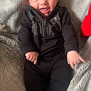 Cathaoir joined the competition — help win amazing prizes! baby, infant, smiling, black_clothing, blanket, soft_texture, happy, cute, child, socks, lying_down, face, portrait, cozy, indoor, small_hands, blue_eyes, casual_wear, expression, young_child