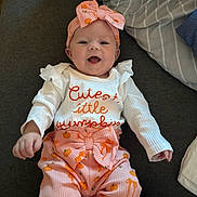 Callie joined the competition — help win amazing prizes! baby, child, infant, smiling, happy, portrait, indoors, couch, pillow, bow, headband, pink_outfit, pumpkin_pattern, seasonal, autumn, white_shirt, sitting, lying_down, baby_clothing, close_up