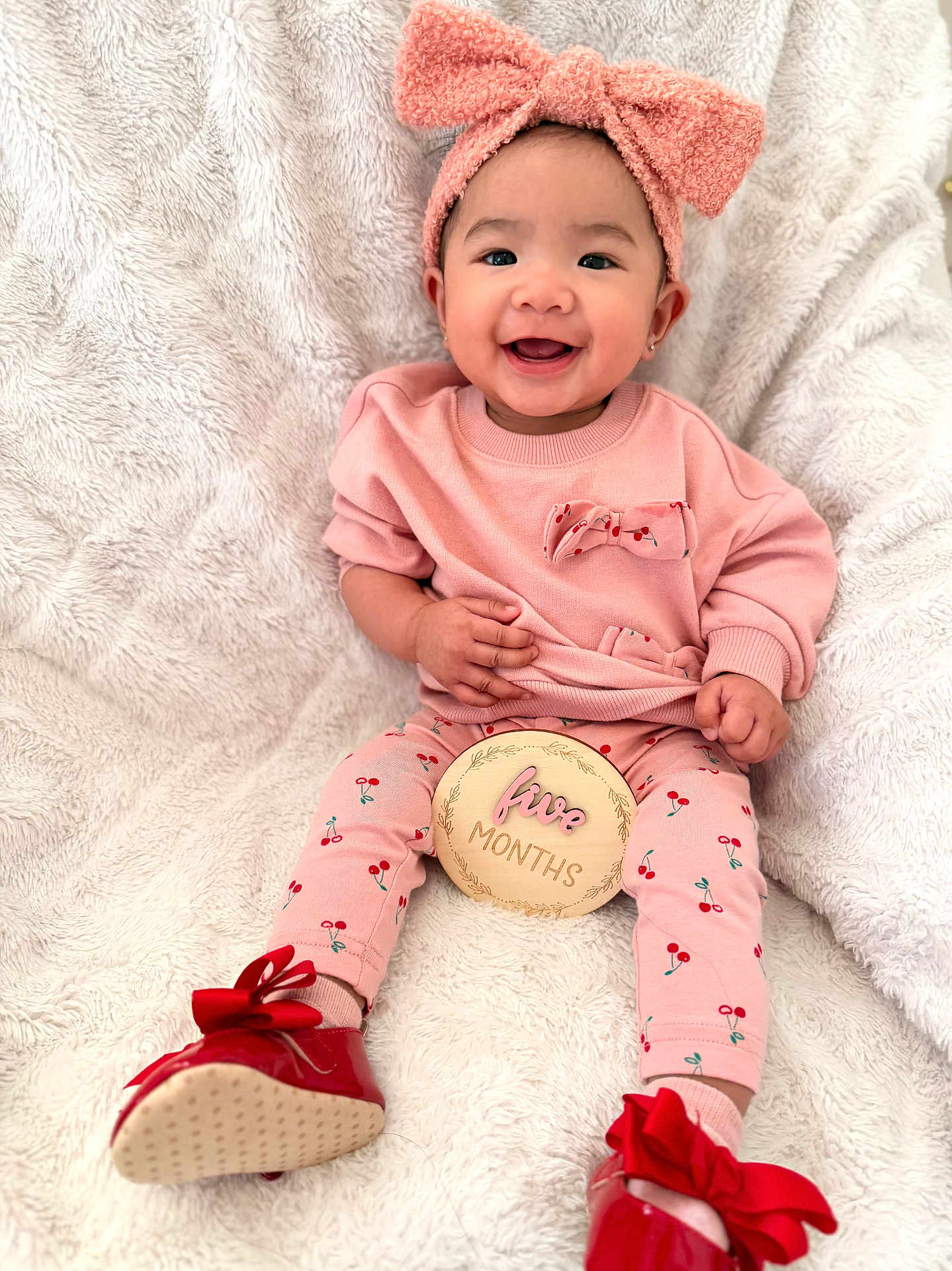 Elisha Jeanah joined the competition — help win amazing prizes! baby, infant, child, smiling, headband, bow, pink_clothing, cherry_print, milestone_disc, five_months, red_shoes, bow_shoes, cozy_blanket, sitting, portrait, happy, cute, earrings, small_hands, soft_texture