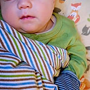 Jesse joined the competition — help win amazing prizes! animal_print, baby, blanket, child, cozy, cute, face, green_clothing, indoors, infant, pattern, peaceful, pillow, portrait, resting, sleeping, soft, striped, wrapped, young_child