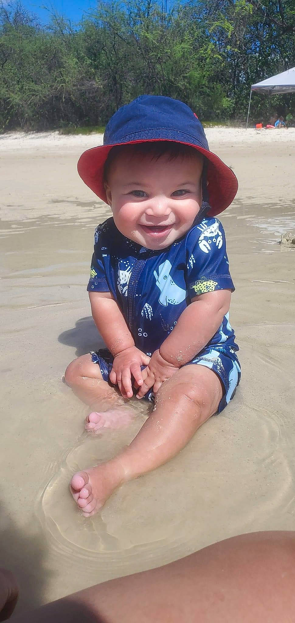 Kobe is registered to the contest to win money with this photo: azure, baby_toddler_clothing, beach, beauty, electric_blue, eye, face, fun, happy, hat, headgear, headwear, leisure, natural_environment, person, skin, sleeve, smile, sun_hat, thigh
