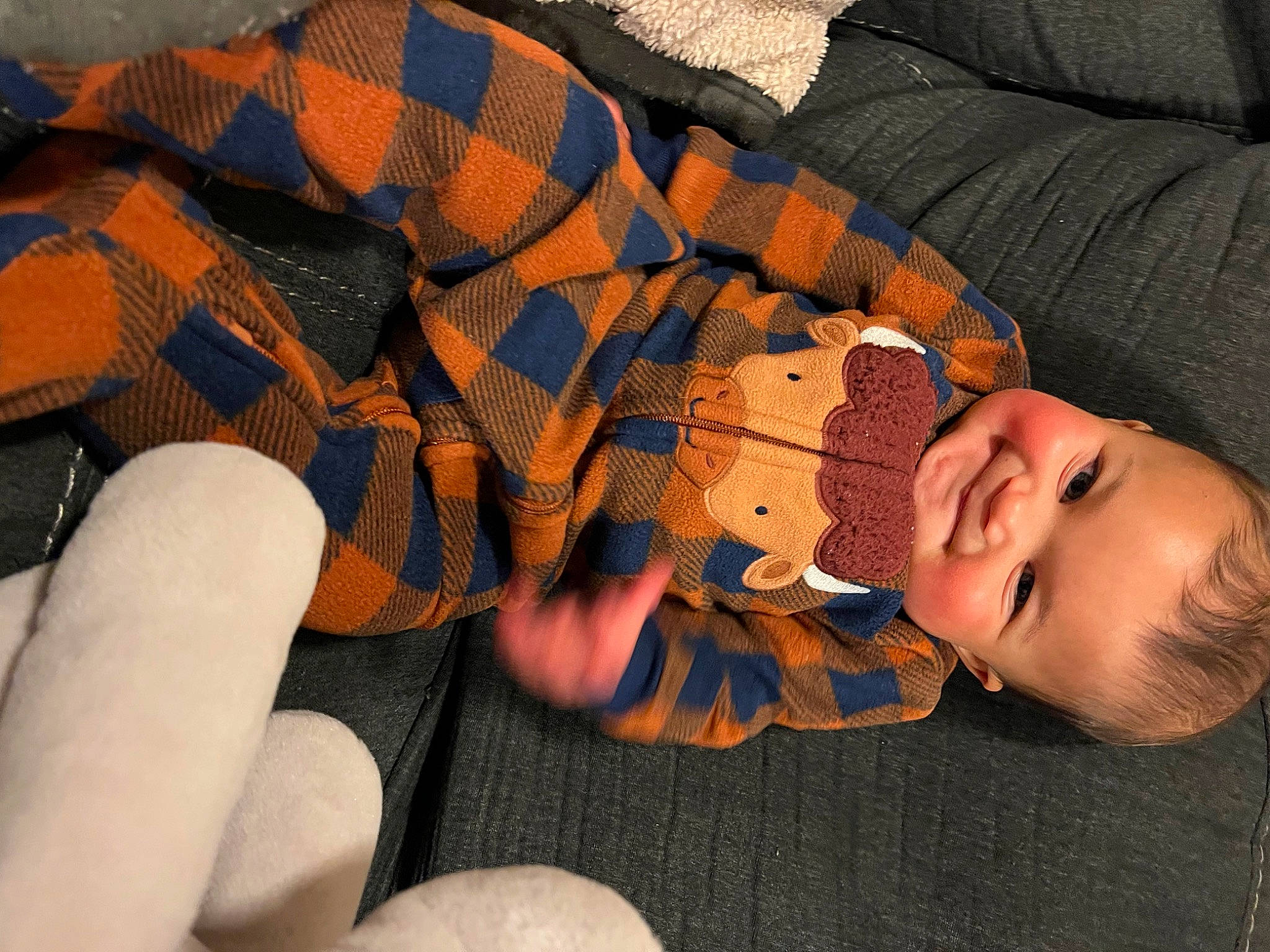 Kobe is registered to the contest to win money with this photo: baby, child, comfort, finger, hand, human_body, human_leg, joy, knee, mouth, nail, orange, pattern, person, plaid, skin, textile, thigh, thumb, toddler