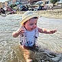 toddler, child, water, beach, sunhat, swimsuit, splashing, sand, umbrella, summer, outdoor, happy, play, vacation, sea, sunny, people, family, holiday, shore