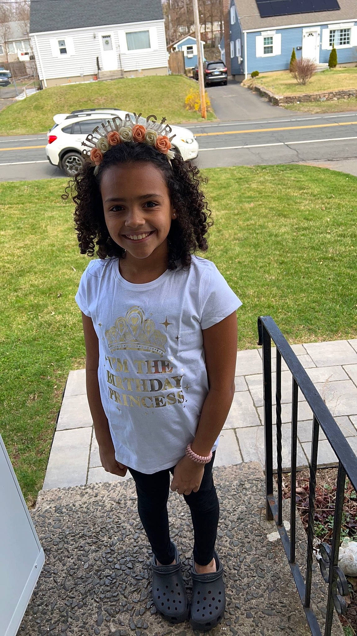 Aiyanna is registered to the contest to win money with this photo: asphalt, car, child, cool, fun, grass, hair, hairstyle, happy, joy, leisure, person, plant, public_space, recreation, sidewalk, sleeve, smile, t_shirt, tire