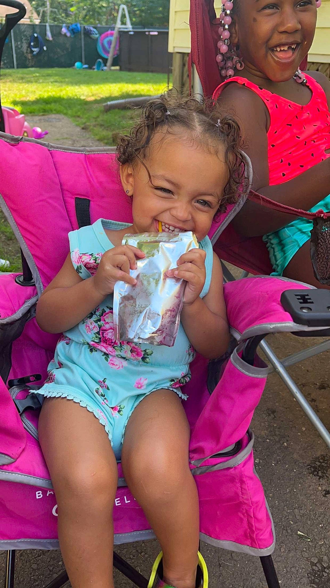 Ariyah is registered to the contest to win money with this photo: child, event, fast_food, finger, fun, happy, headwear, joy, leg, leisure, magenta, mouth, person, pink, recreation, shorts, sitting, skin, smile, summer