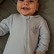 Tp joined the competition — help win amazing prizes! baby, smiling, onesie, infant, child, cute, happy, face, clothing, lying_down, soft_surface, portrait, young_child, sleepwear, zipped, indoor, human, skin, head, expression