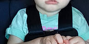 Aria Dawn is registered to the contest to win money with this photo: child, toddler, baby, car_seat, seatbelt, harness, blue_eyes, short_hair, hands, snack, vehicle_interior, portrait, closeup, sitting, seat_buckle, pink_button, unfocused, soft_lighting, serious_expression, infant_clothing