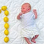 baby, bed, blanket, bodypart, citrusfruit, face, finger, food, fruit, furniture, grapefruit, hand, head, lemon, newborn, person, photography, plant, portrait, produce
