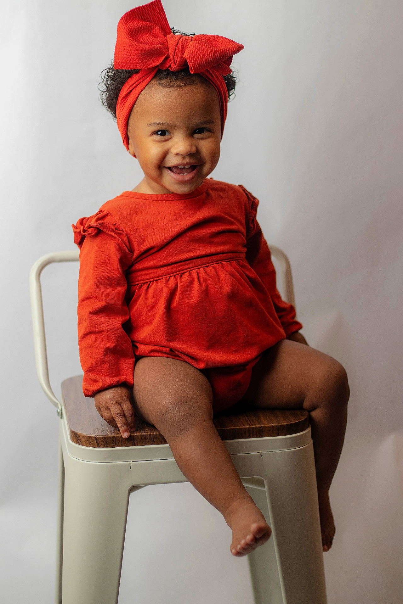 Amelia is registered to the contest to win money with this photo: baby, babylaughing, barstool, bodypart, chair, clothing, dress, eveningdress, face, finger, formalwear, furniture, hand, happy, head, person, photography, portrait, sitting, smile