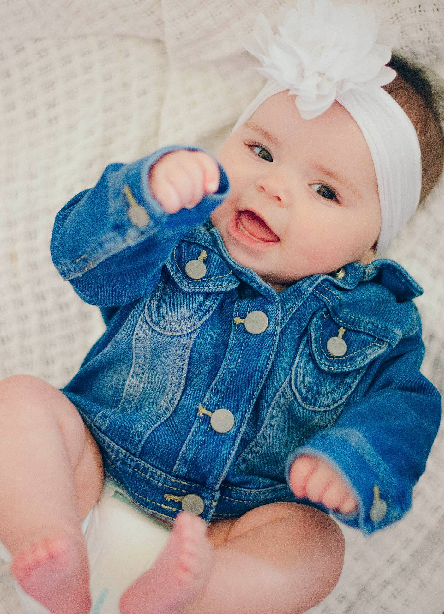Abrielle is registered to the contest to win money with this photo: blue, child, girl, hair_accessory, hand, headgear, infant, person, product, skin, smile, textile, toddler