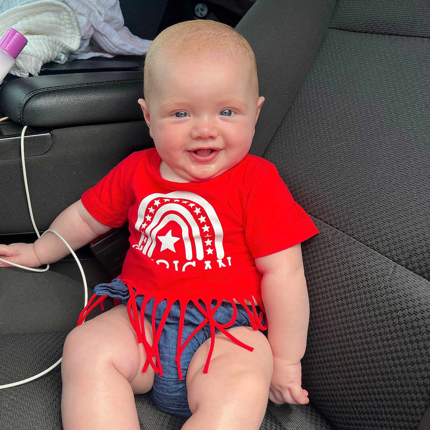 Kinsley Mae joined the competition — help win amazing prizes! baby, car, clothing, couch, cushion, face, footwear, furniture, happy, head, homedecor, pants, person, photography, portrait, shorts, sitting, t_shirt, transportation, vehicle