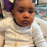 Halo joined the competition — help win amazing prizes! toddler, child, baby, curly_hair, bows, white_shirt, denim_jeans, necklace, gold, indoor, baby_seat, cute, portrait, sitting, jewelry, expressionless, curious, young_child, person, closeup