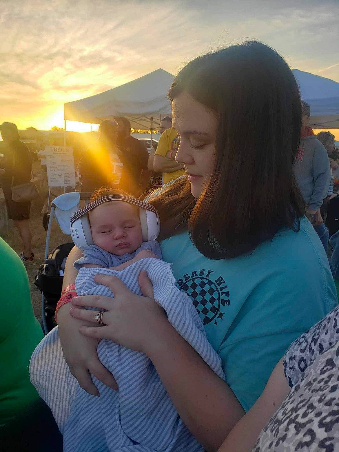 Owen is registered to the contest to win money with this photo: baby, beauty, event, fun, gesture, grass, hairstyle, happy, interaction, landscape, leisure, person, recreation, shoulder, sitting, sky, smile, summer, t_shirt, toddler