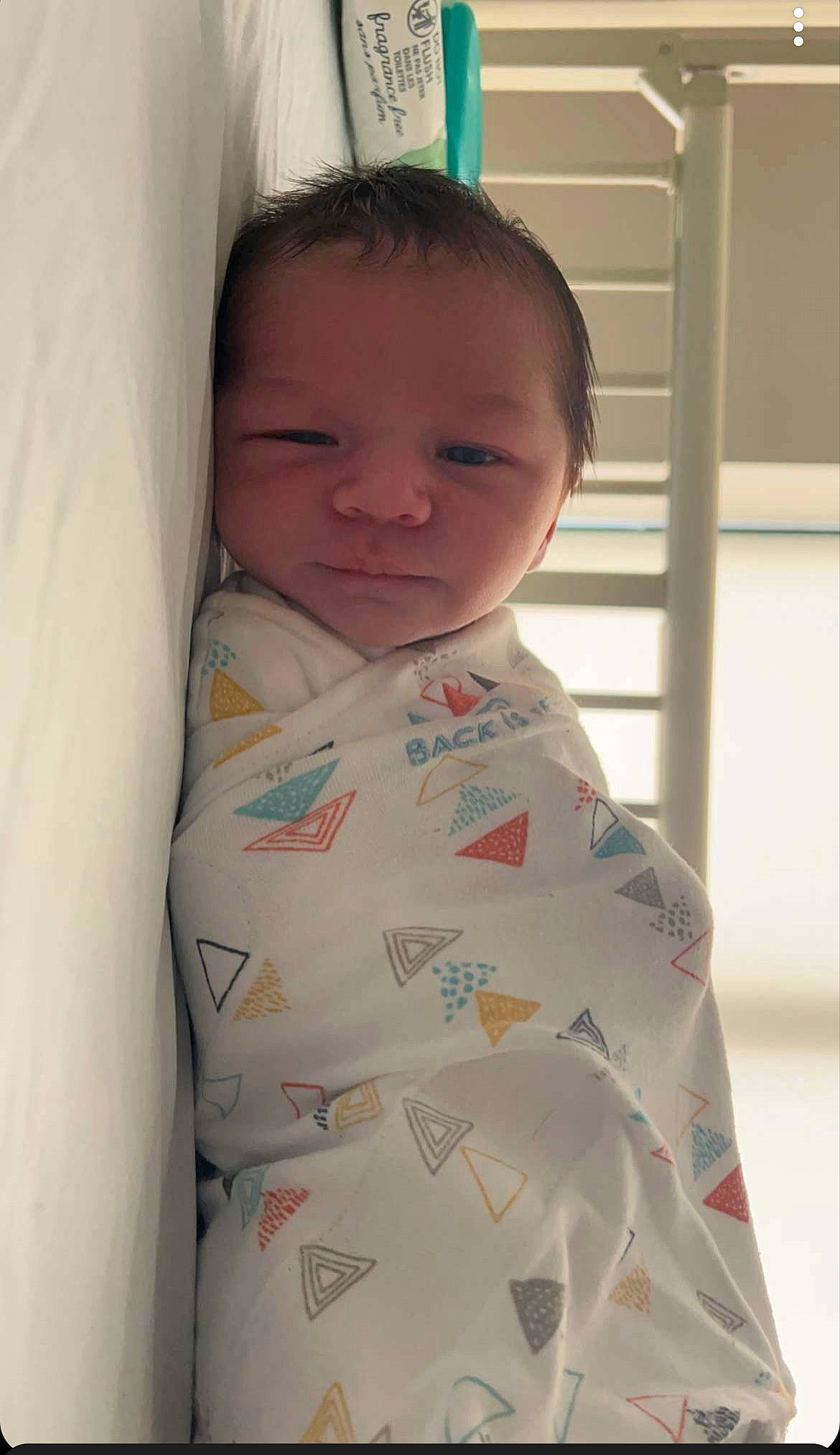 Owen is registered to the contest to win money with this photo: baby, baby_products, baby_toddler_clothing, bedding, cheek, child, collar, comfort, eyebrow, face, linens, neck, nose, pattern, person, room, shoulder, sleeve, smile, t_shirt