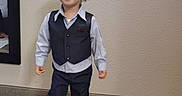 Jayden joined the competition — help win amazing prizes! child, toddler, boy, smiling, happy, portrait, standing, walking, formalwear, vest, dress_shirt, bow_tie, trousers, dress_shoes, curly_hair, indoors, hallway, carpet, wall, mirror