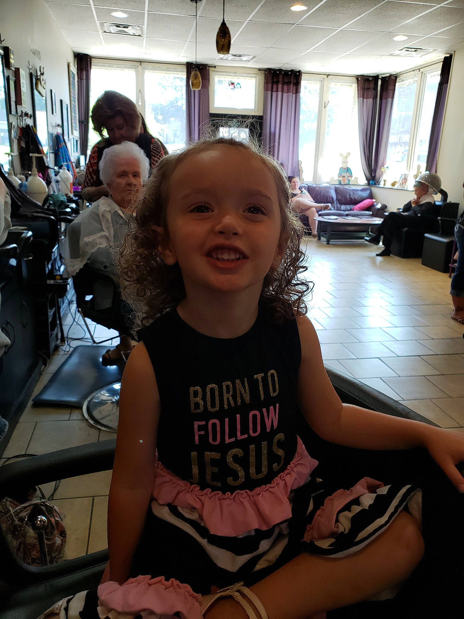 Joslyn is registered to the contest to win money with this photo: child, fun, joy, leg, person, room, sitting, smile, t_shirt