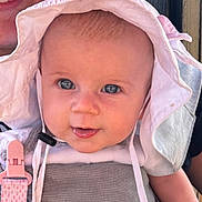 Quinn joined the competition — help win amazing prizes! baby, child, face, hat, sun_hat, blue_eyes, close_up, smile, outdoor, daylight, person, cute, infant, clothing, straps, pink_clip, happy, skin, headwear, portrait