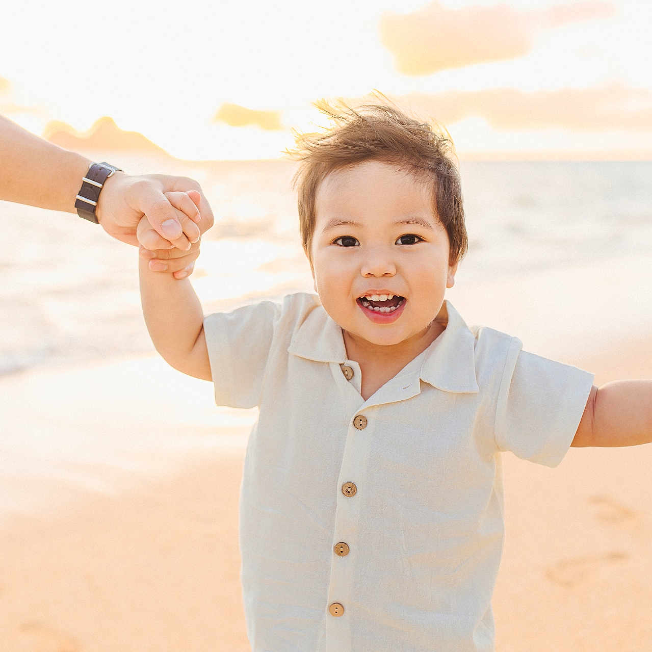 Artem is registered to the contest to win money with this photo: baby, babylaughing, beach, beachwear, bodypart, clothing, coast, face, finger, hand, happy, head, holdinghands, nature, outdoors, person, photography, portrait, shirt, smile