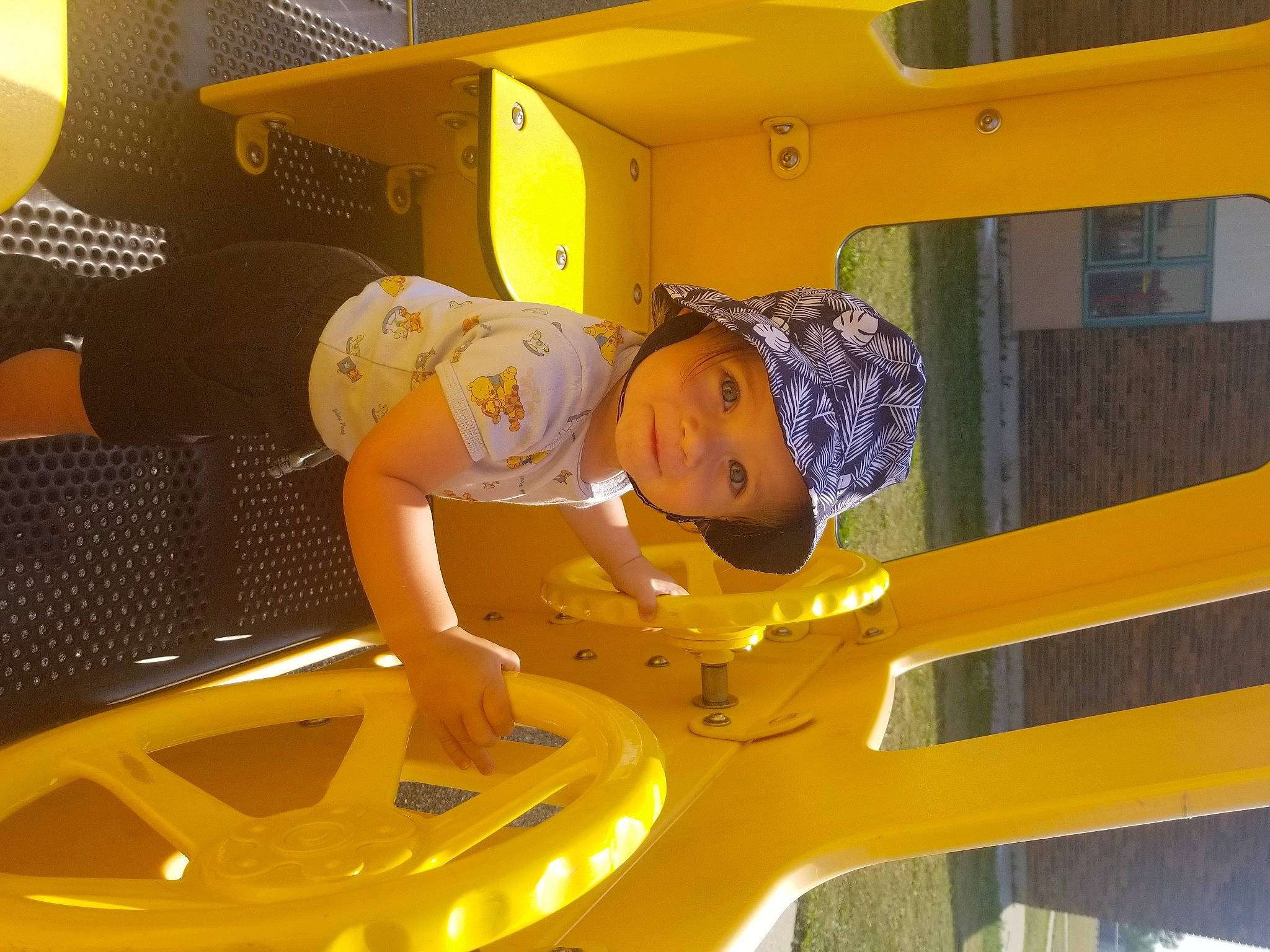 Noa is registered to the contest to win money with this photo: amusement_ride, automotive_exterior, baby, bumper, child, chute, city, fun, happy, headwear, leisure, nonbuilding_structure, outdoor_play_equipment, person, play, playground, playground_slide, recreation, smile, toddler