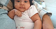 Laylah-Marie is registered to the contest to win money with this photo: arm, baby, book, casual, child, comfort, couch, cozy, curly_hair, dragonfly_print, expression, hand, indoor, infant, person, pigtails, pink_outfit, portrait, skin, table