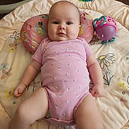 Shaylyn joined the competition — help win amazing prizes! baby, infant, pink_onesie, play_mat, toy, crocheted_blanket, floor, carpet, child, cute, smile, face, head, skin, legs, arms, indoor, relaxing, colorful, comfort