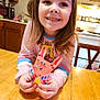 Addy is registered to the contest to win money with this photo: child, girl, smiling, craft, bunny, handmade, colorful, table, kitchen, wooden_table, long_hair, indoors, happy, person, art, toy, face, sitting, playful, home