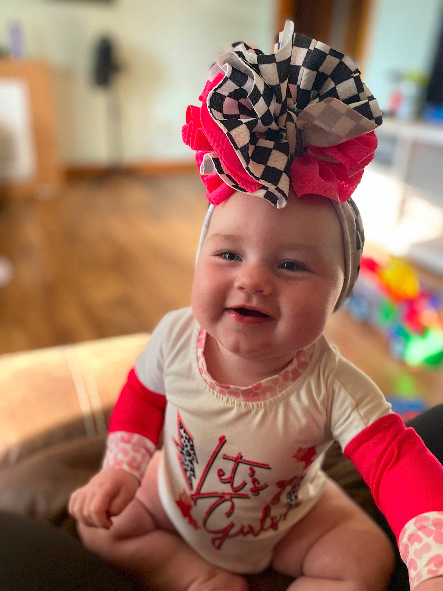 Indie joined the competition — help win amazing prizes! baby, baby_toddler_clothing, cap, child, costume_hat, facial_expression, fashion_accessory, fun, hair_accessory, happy, headgear, headpiece, headwear, joy, magenta, party_supply, person, pink, red, sitting