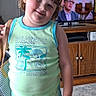 Ruby joined the competition — help win amazing prizes! child, smiling, indoor, living_room, television, painting, cabinet, carpet, shorts, tank_top, person, furniture, happy, cute, hair, face, standing, green_clothing, toddler, home