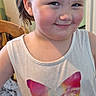 Ruby is registered to the contest to win money with this photo: child, girl, smiling, tank_top, butterfly, hair, ponytail, kitchen, chair, frying_pans, cabinet, window, wooden_chair, person, indoor, casual, cute, portrait, young, happy