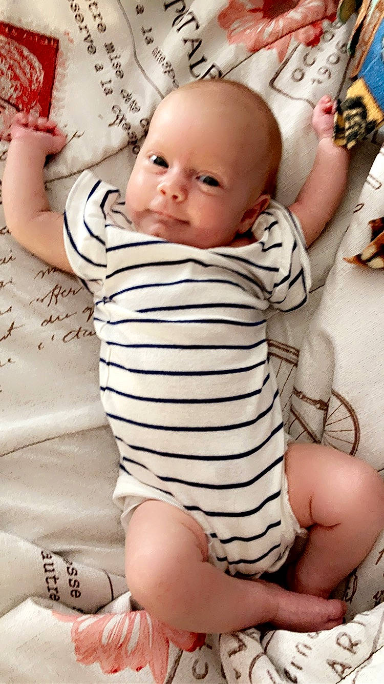 Libby is registered to the contest to win money with this photo: baby, baby_toddler_clothing, cheek, facial_expression, finger, gesture, hairstyle, happy, head, lip, mouth, neck, nose, organ, person, pink, skin, sleeve, smile, stomach