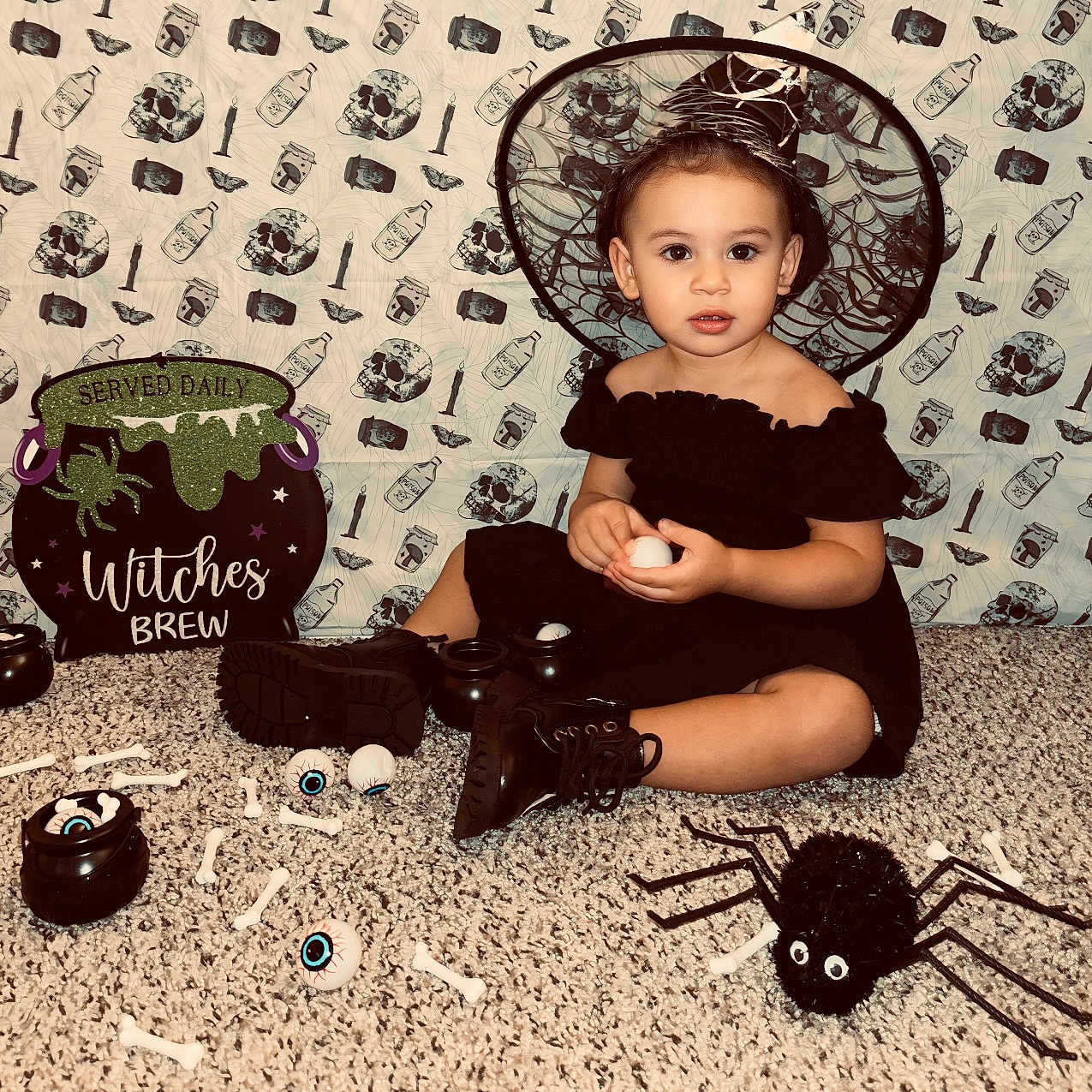 Stella is registered to the contest to win money with this photo: accessories, animal, baby, candle, clothing, dress, egg, face, food, footwear, hat, head, invertebrate, person, photography, portrait, pottery, shoe, sitting, spider