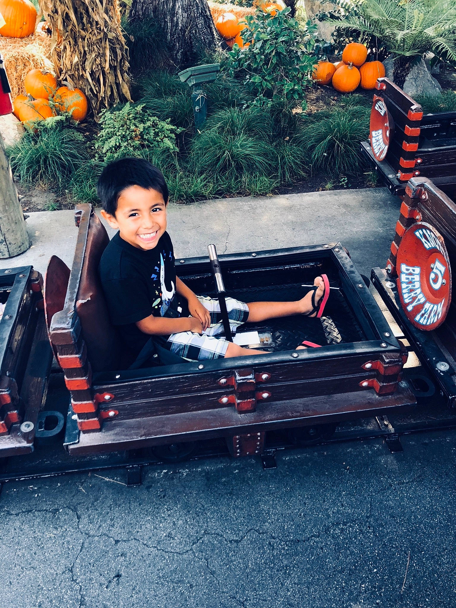 Isaiah is registered to the contest to win money with this photo: black_hair, bumper, car, joy, person, photography, plant, sitting, table, vacation, vehicle