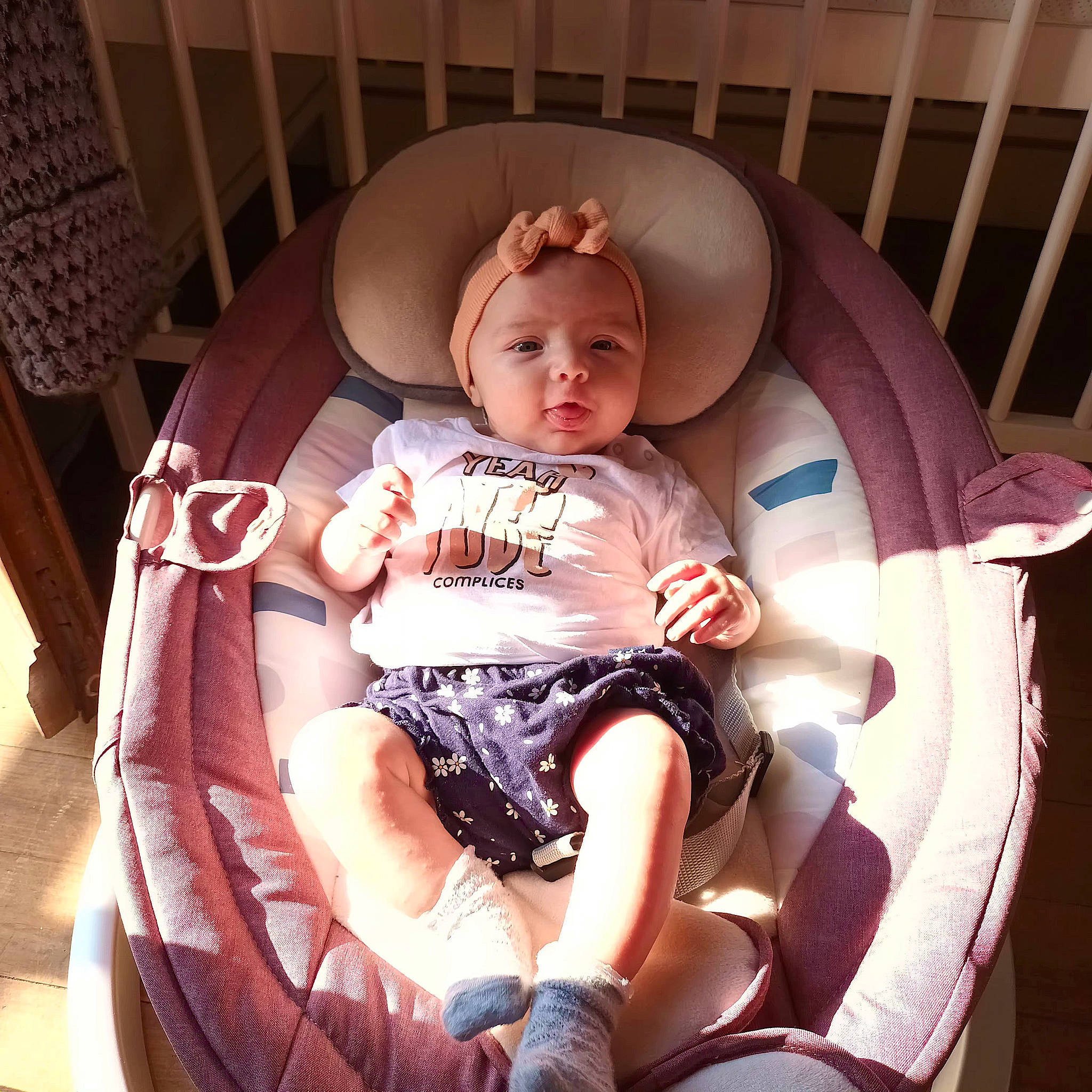 Selena participe au concours pour gagner de l'argent avec cette photo : baby, baby_products, baby_toddler_clothing, car_seat, carmine, chair, child, circle, comfort, human_leg, lap, person, pink, product, room, sitting, thigh, toddler