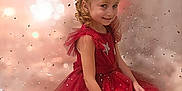Inés a rejoint le concours — aidez-le/la à gagner de superbes lots ! child, girl, red_dress, sparkles, bokeh, confetti, smile, curly_hair, bow, party, celebration, portrait, happy, sitting, festive, cute, fashion, elegant, background, magic