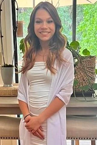 Angelique is registered to the contest to win money with this photo: chair, day_dress, elbow, event, fashion_accessory, fashion_design, formal_wear, happy, houseplant, human_leg, joint, joy, neck, one_piece_garment, person, plant, shoulder, sleeve, smile, thigh