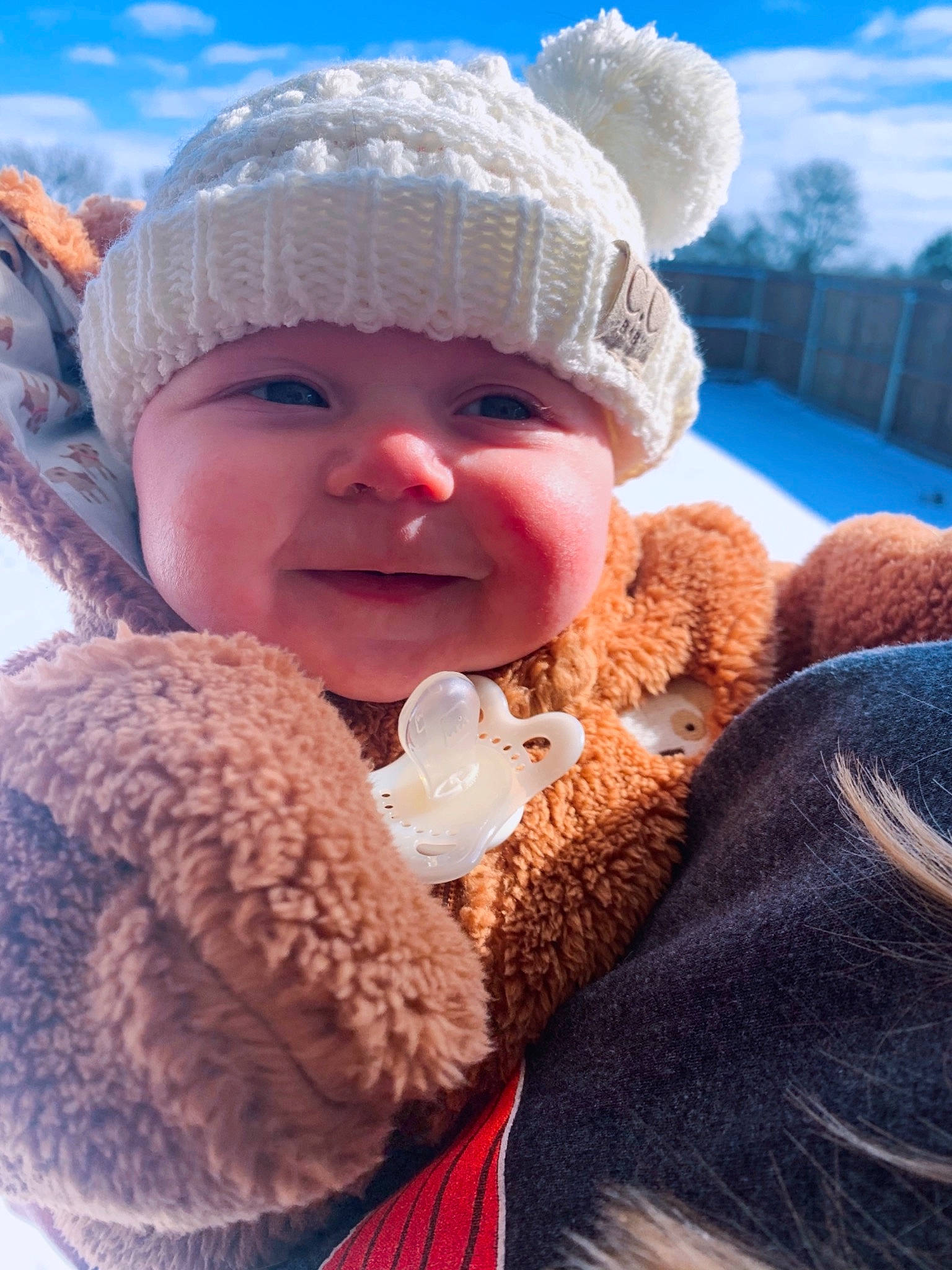 Charity is registered to the contest to win money with this photo: baby, blue, cap, cheek, child, cloud, comfort, fun, happy, headgear, headwear, human_body, knit_cap, nose, person, skin, sky, smile, toddler, winter