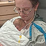 Conan joined the competition — help win amazing prizes! mother, newborn, baby, hospital, medical_tubes, blanket, gown, indoor, woman, child, glasses, care, love, holding, patient, bedroom_furniture, medical_care, tender, hospital_room, face