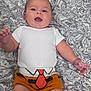 Jasper joined the competition — help win amazing prizes! baby, infant, child, smiling, happy, onesie, shorts, tie_design, bedspread, patterned_fabric, lying_down, indoor, portrait, skin, hand, face, head, blue_eyes, cute, chubby