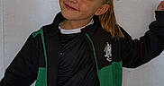 Shayness participe au concours pour gagner de l'argent avec cette photo : black_clothing, casual, child, emoji, girl, green_clothing, hair_tied_back, happy, indoor, light_background, long_hair, person, portrait, pose, smiling, sport_jacket, sportswear, standing, wall, young