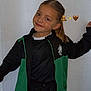 Shayness participe au concours pour gagner de l'argent avec cette photo : child, girl, smiling, pose, sport_jacket, black_clothing, green_clothing, long_hair, wall, indoor, casual, happy, young, portrait, person, standing, sportswear, hair_tied_back, emoji, light_background
