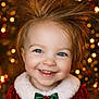 blue_eyes, bokeh, child, christmas, closeup, cute, face, festive, green_bow, hair_spikes, happy, holiday, holiday_decor, indoor, joyful, portrait, red_dress, smiling, toddler, warm_lighting