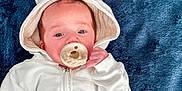 Noah is registered to the contest to win money with this photo: baby, pacifier, hoodie, bunny_ears, white_clothing, blue_blanket, infant, cute, lying_down, soft_texture, face, hand, sleepwear, child, portrait, young, cozy, comfort, indoors, baby_girl_boy
