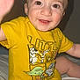 baby, child, smiling, yellow_shirt, star_wars, toddler, happy, face, eyes, hand, sitting, cute, indoors, clothing, infant, person, portrait, skin, short_hair, bed